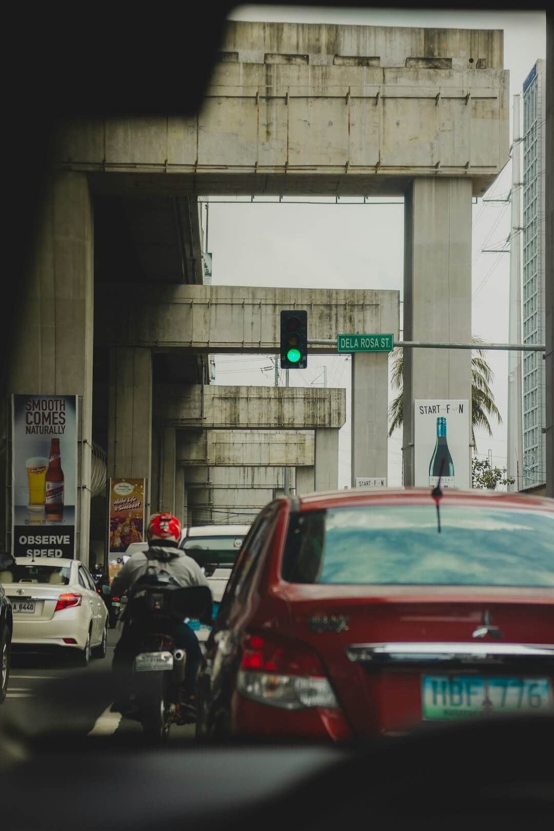 a person riding a motorcycle next to a traffic light