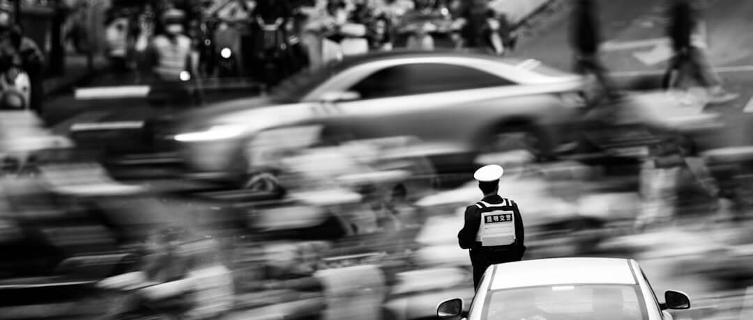 Traffic officer directing cars in a busy street.