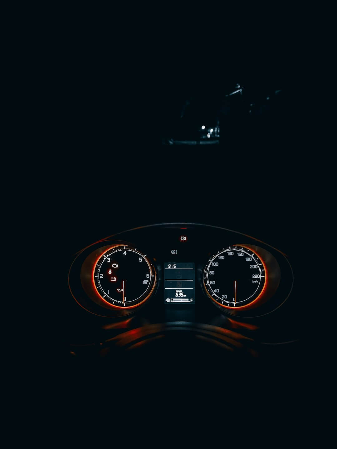 the dashboard of a car in the dark