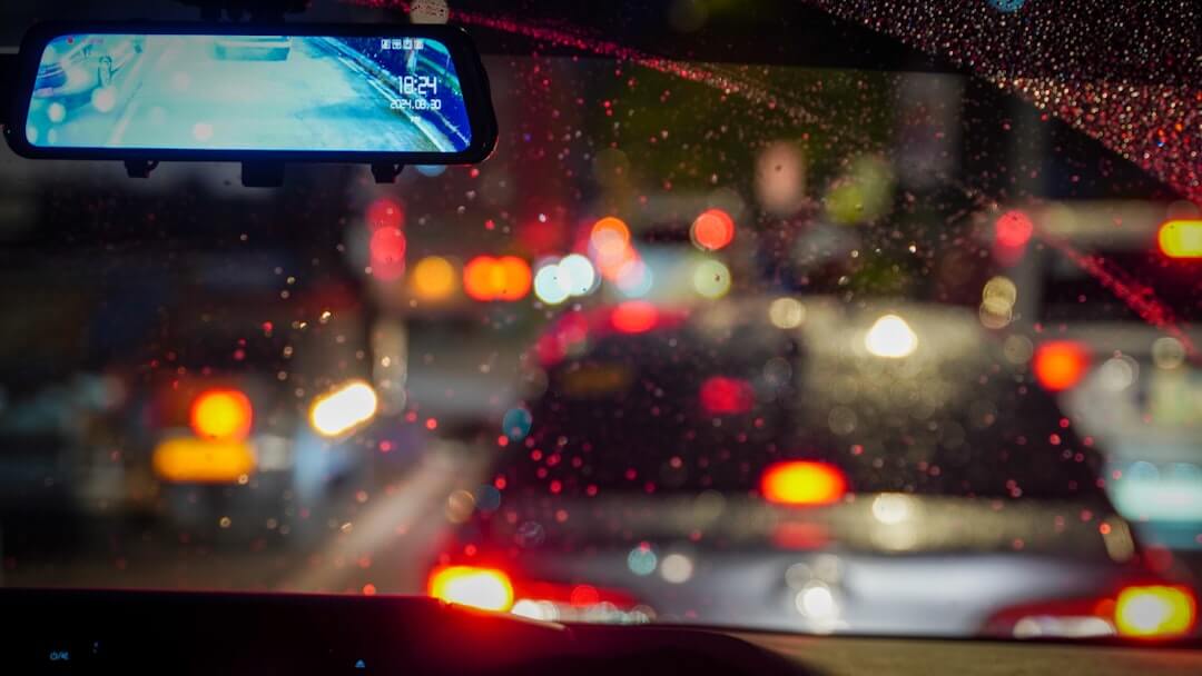 A view from inside a car of traffic on a rainy night