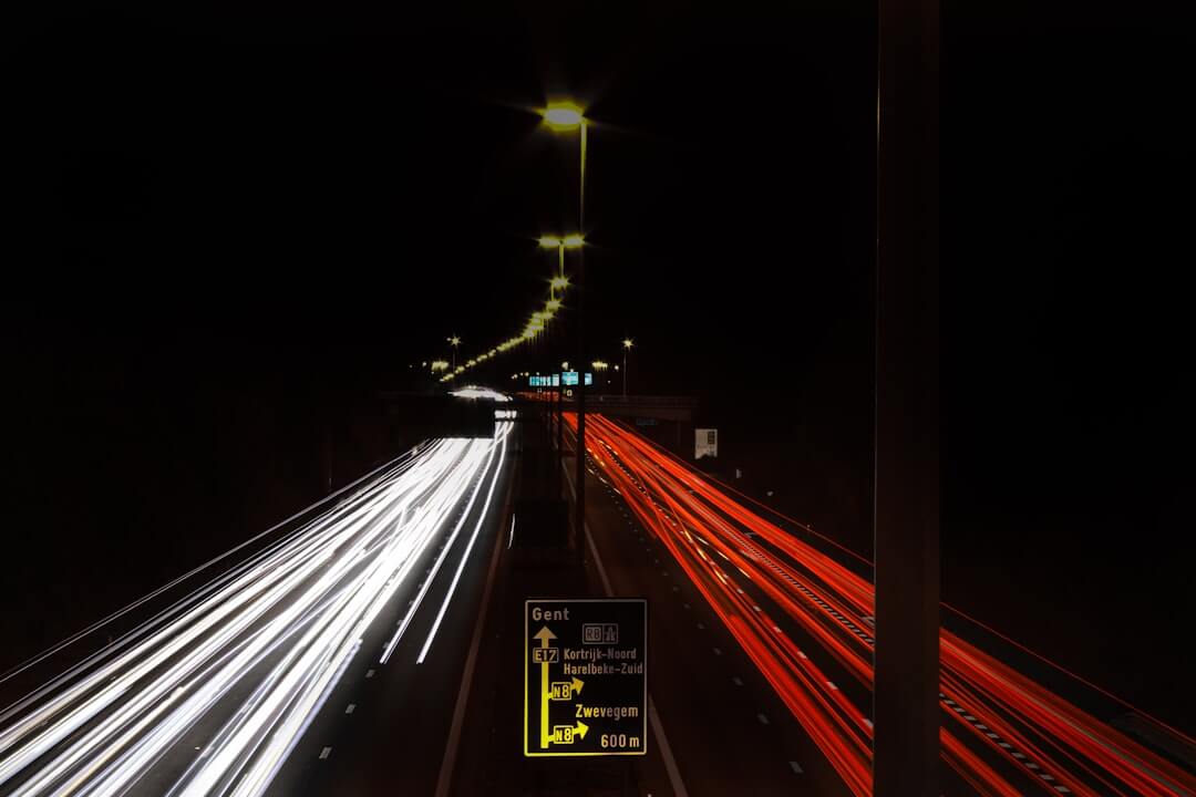 a long exposure photo of a highway at night