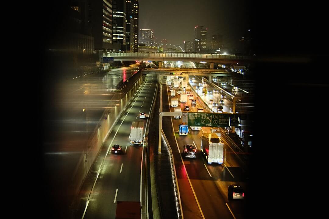 a city street filled with lots of traffic at night