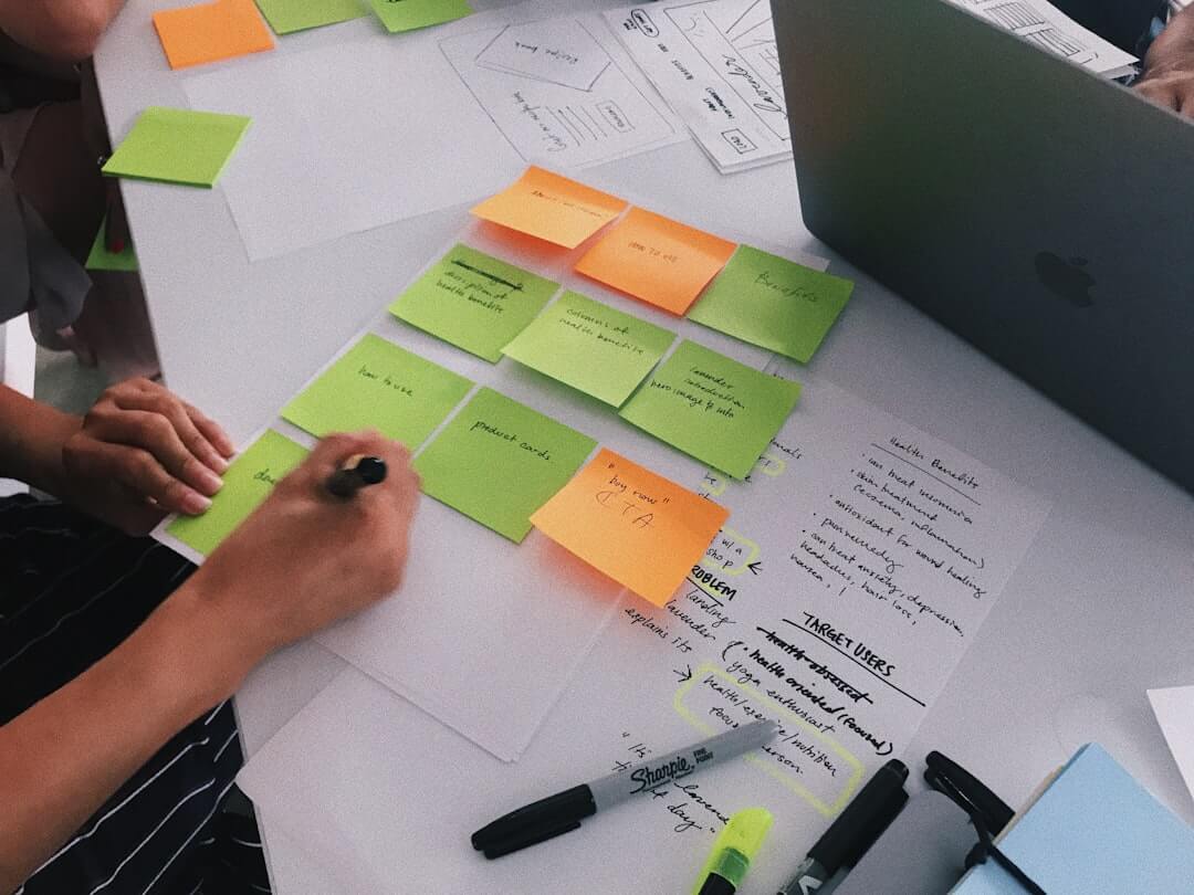 person writing on sticky notes