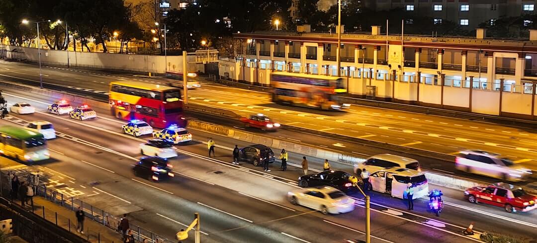Traffic is moving on a multi-lane highway at night.