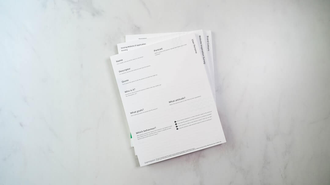 a stack of papers sitting on top of a white counter