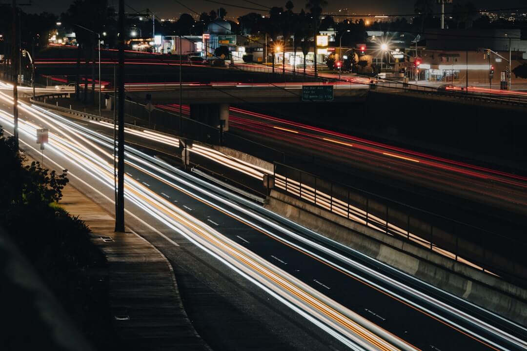a city street filled with lots of traffic at night