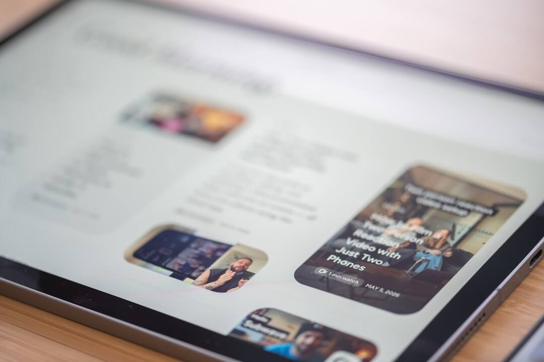 A tablet displaying a website with images and text content.