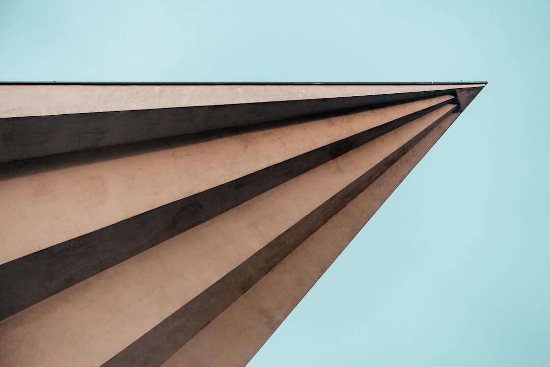 triangular brown concrete tower