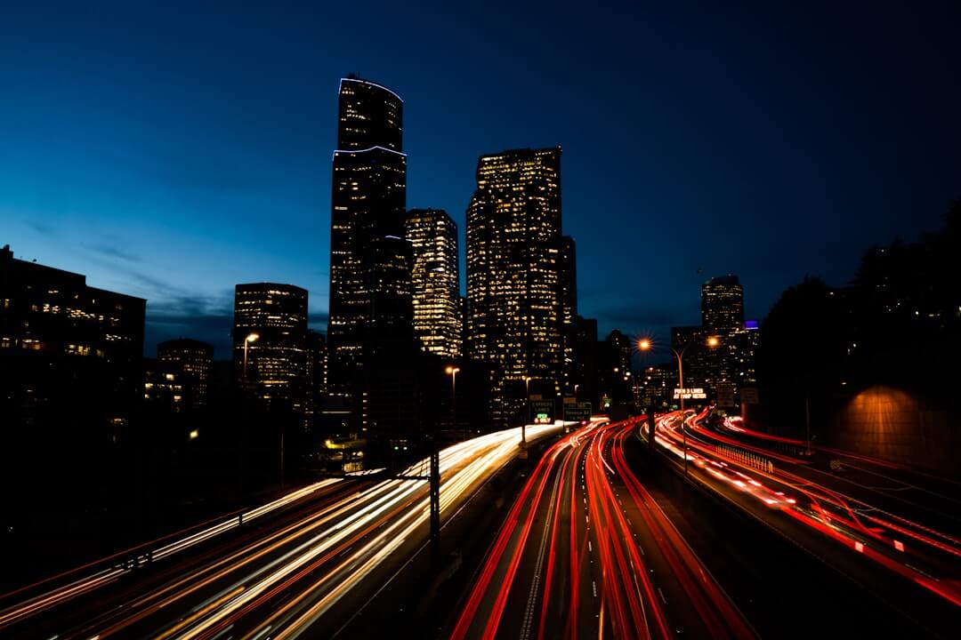 a view of a city at night from a bridge
