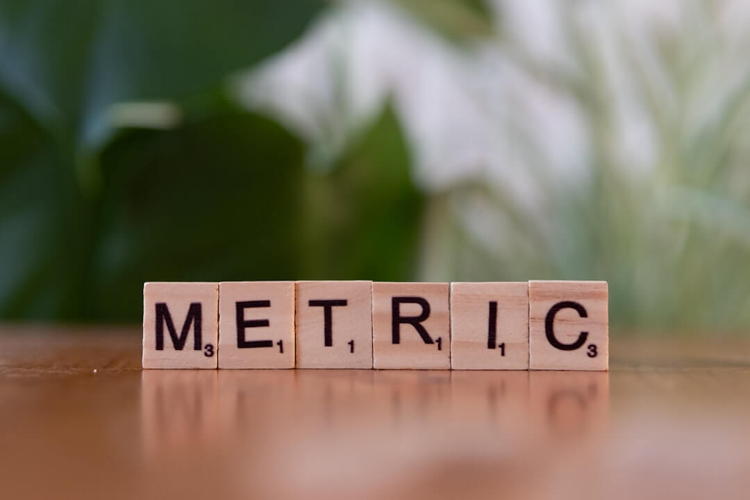 A wooden block spelling the word metallic on a table