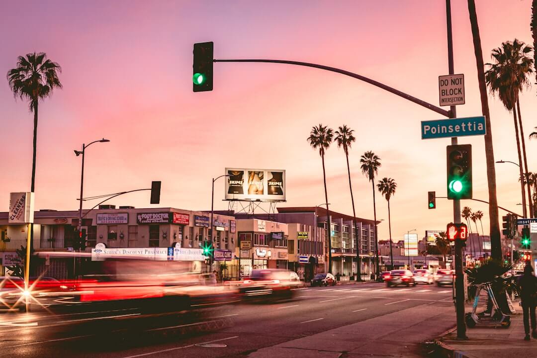Sunset paints the sky over a bustling city street.