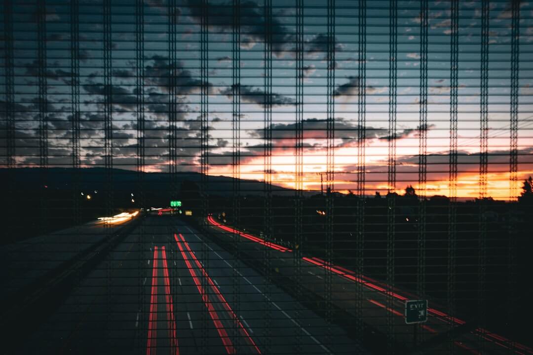Highway traffic at dusk with light trails.