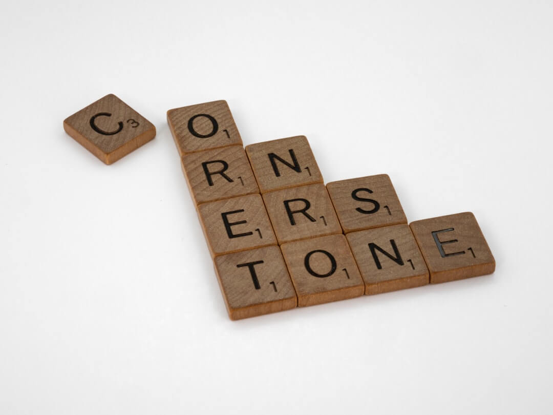 scrabble tiles spelling the word correrstone on a white background