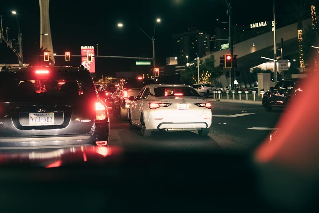 Cars in traffic at night with city lights