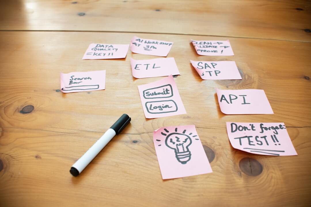 Sticky notes with words and drawings on wooden table