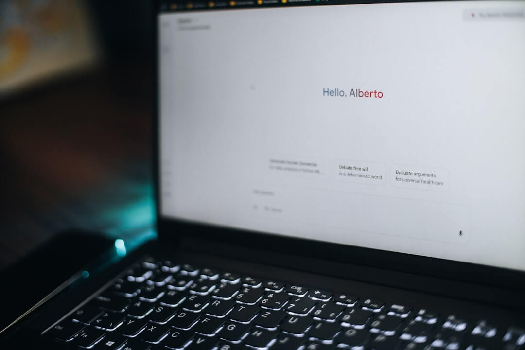 A laptop displays "hello, alberto" on its screen