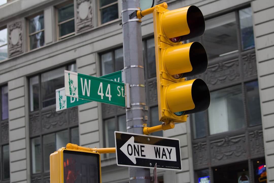 a traffic light with a one way sign on it