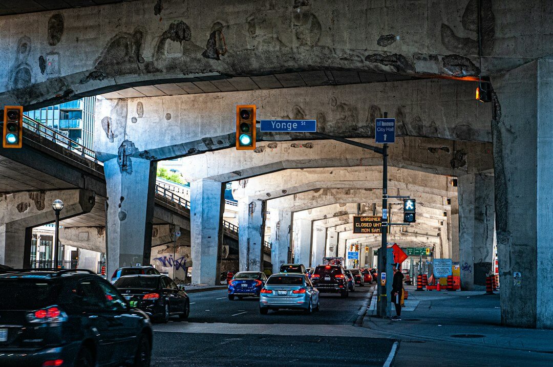 a street filled with lots of traffic under a bridge