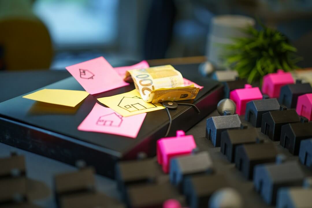 Miniature houses and sticky notes with house drawings