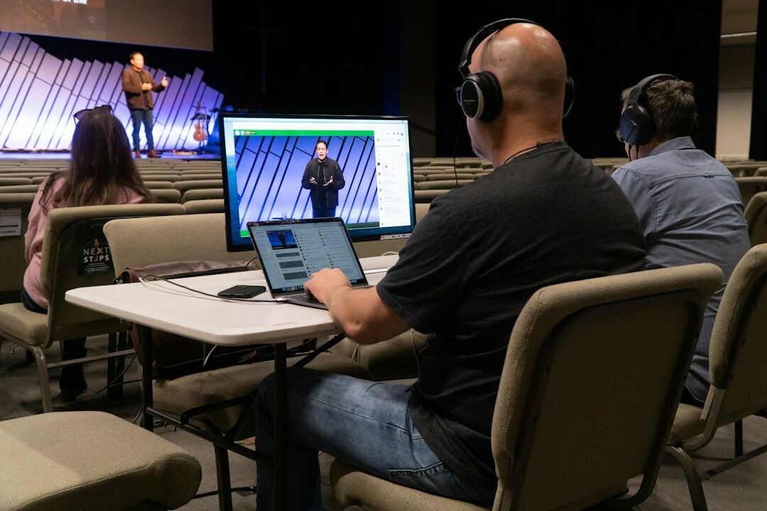 man in black crew neck t-shirt using black laptop computer