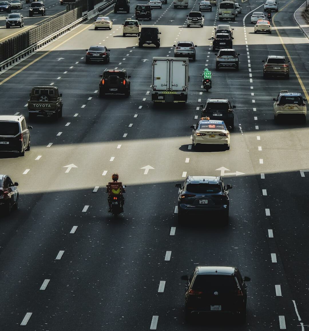 Cars and motorbikes move along a busy highway