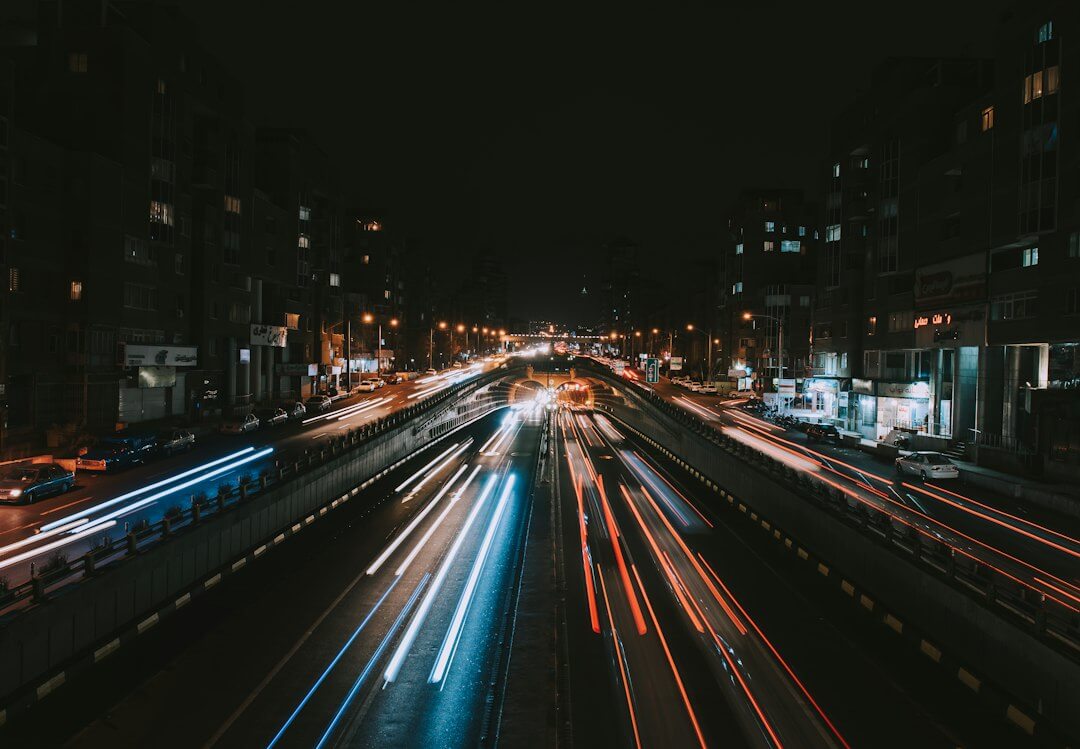 a city street filled with lots of traffic at night