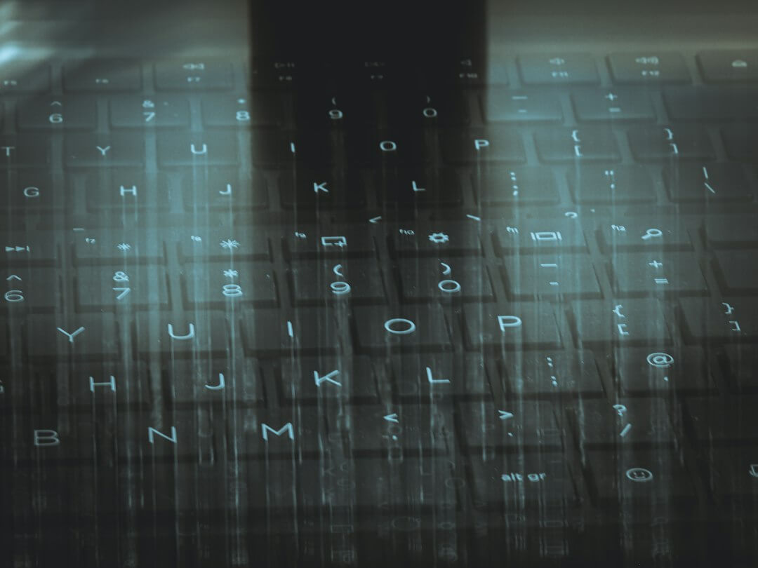A computer keyboard with a sky background