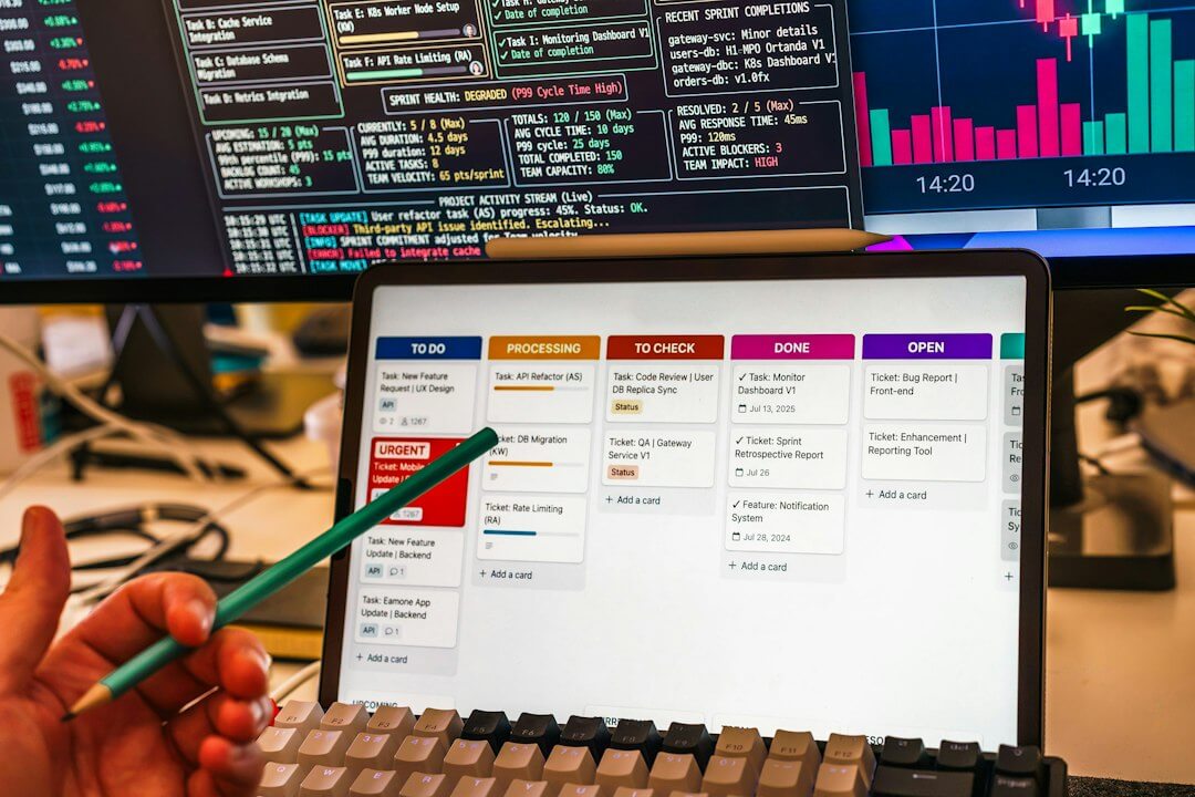 A person pointing at a digital kanban board on a tablet screen