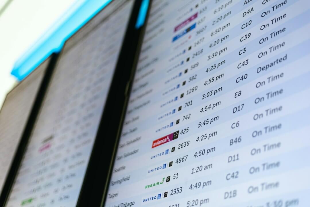 A digital flight information display board showing airline schedules and status updates