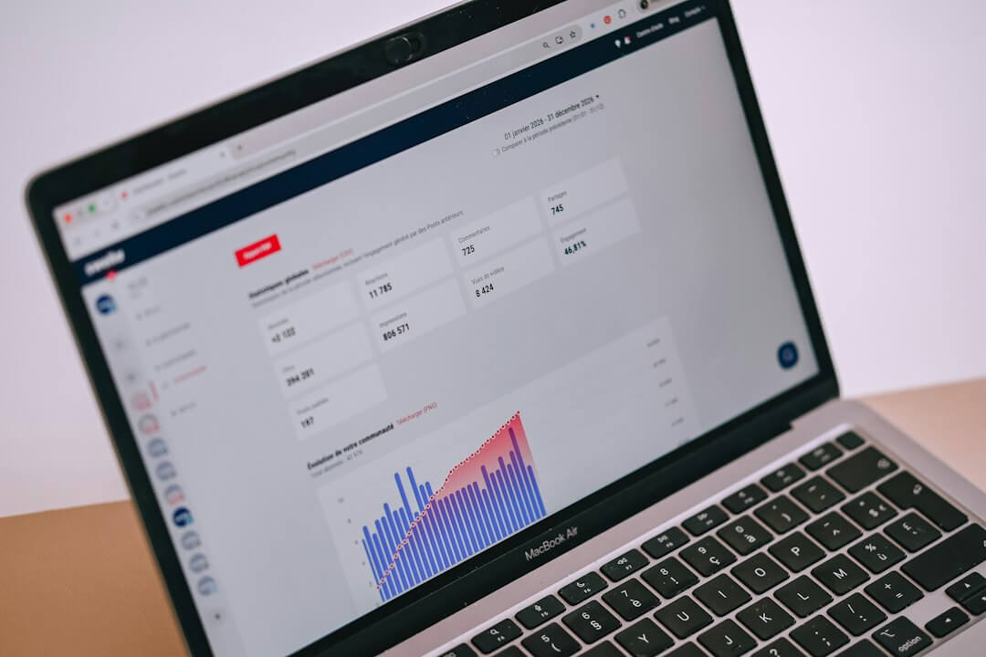 A laptop screen displays data analytics, charts, and statistics
