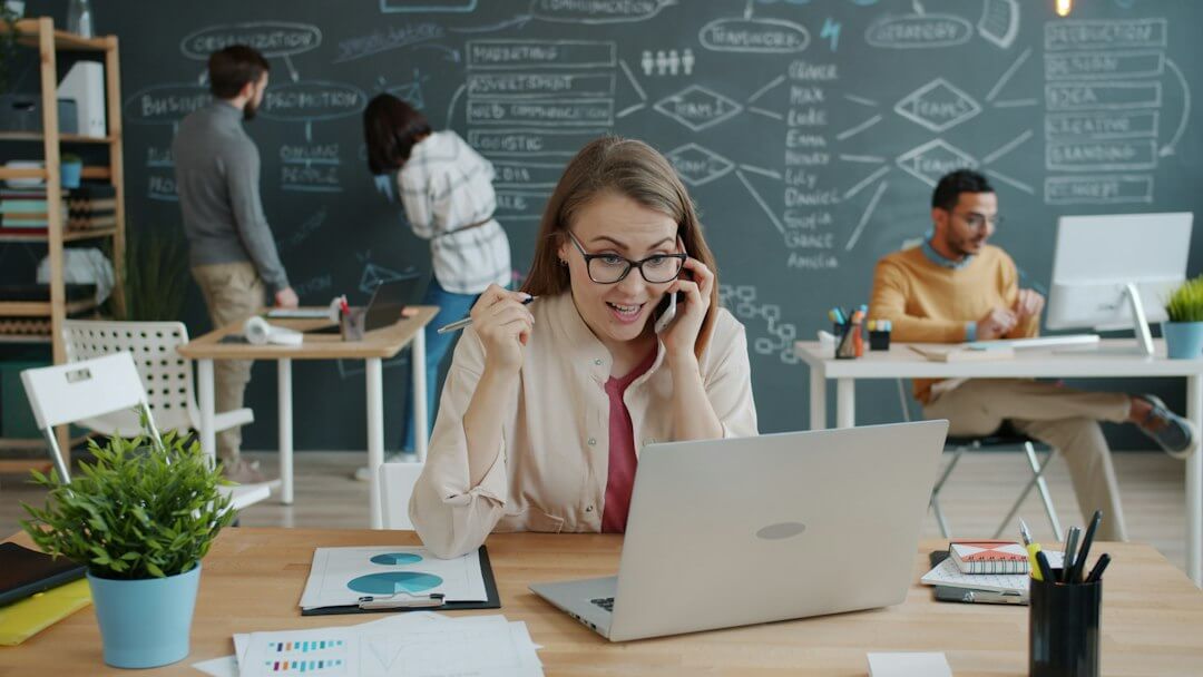 Woman celebrating success while on a business call